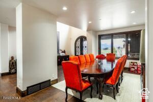 Dining space with dark hardwood / wood-style floors