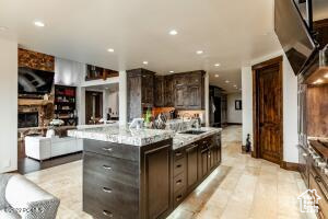 Kitchen with a kitchen island and dark brown cabinets