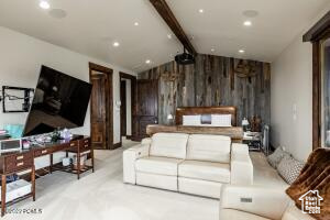 Bedroom featuring light colored carpet and wooden walls