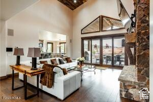 Living room with hardwood / wood-style floors and high vaulted ceiling