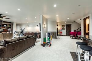 Living room featuring light carpet and ceiling fan