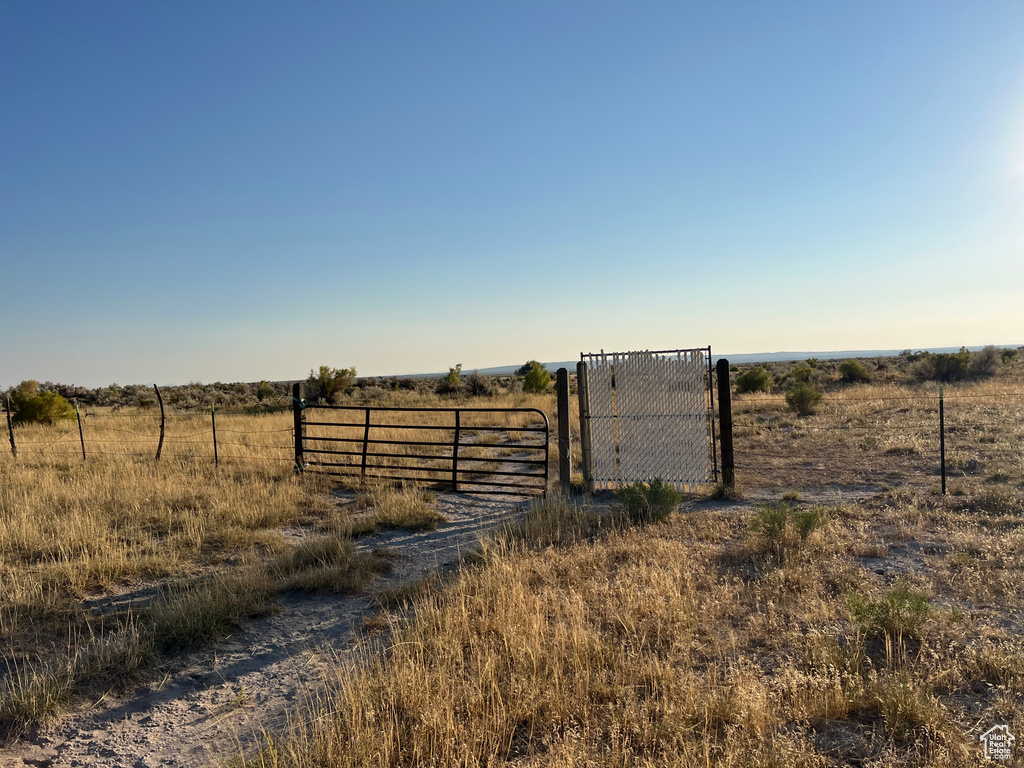 View of gate with a rural view