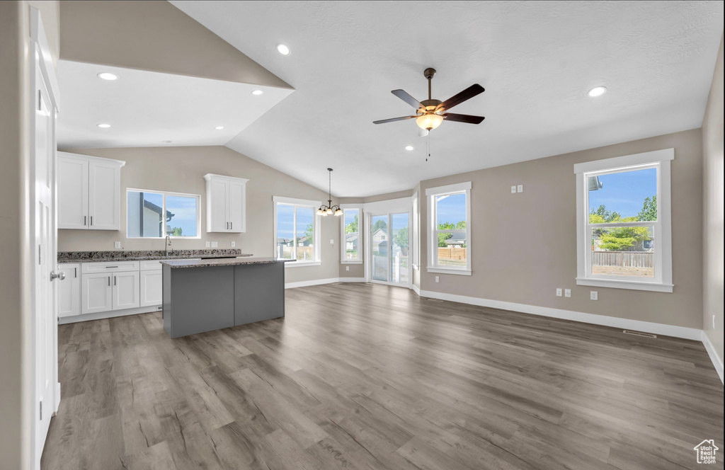 Kitchen featuring a center island, white cabinetry, and hardwood / wood-style floors