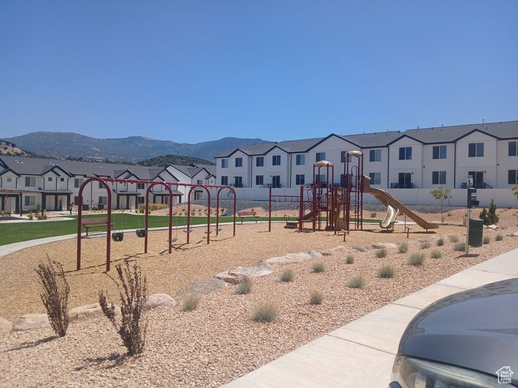 View of playground featuring a mountain view