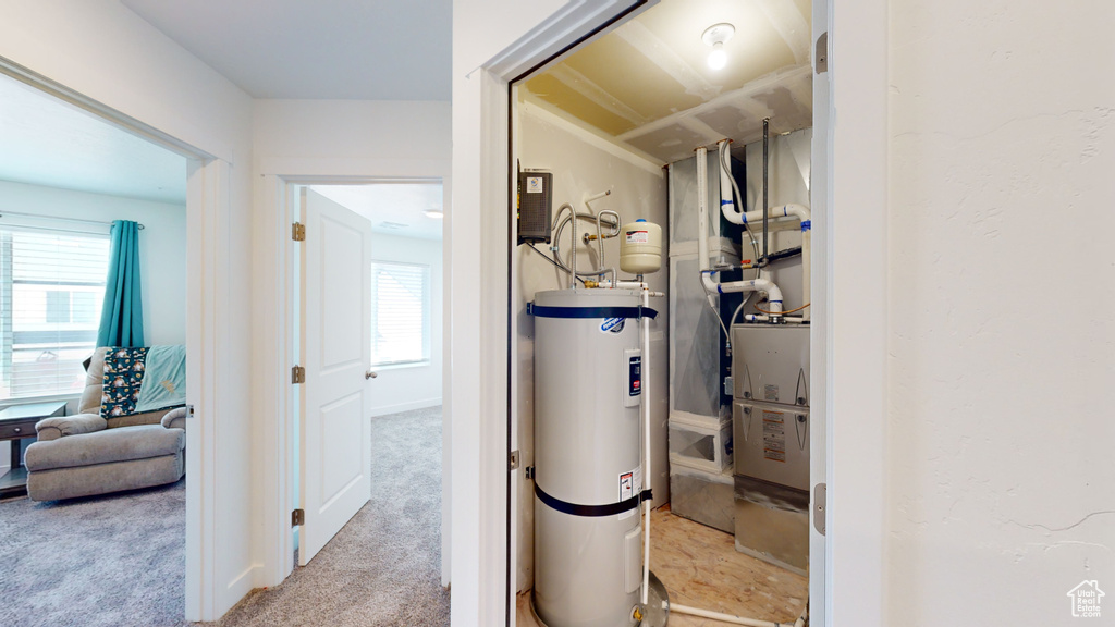 Utility room featuring secured water heater