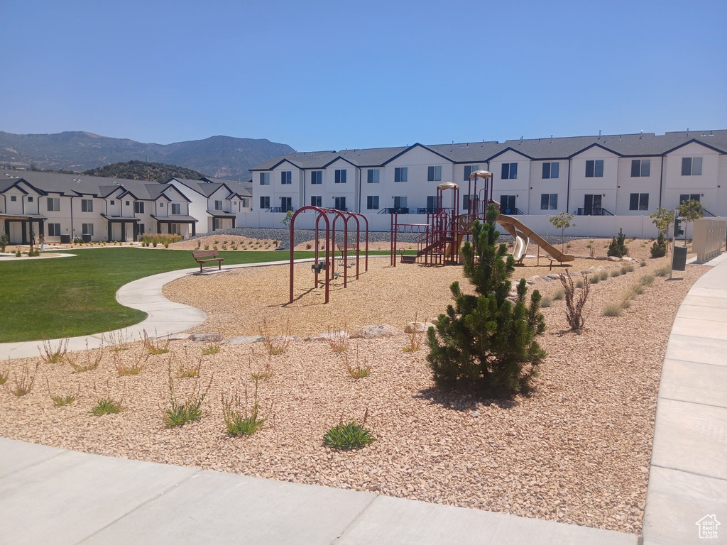 Surrounding community with a mountain view and a playground