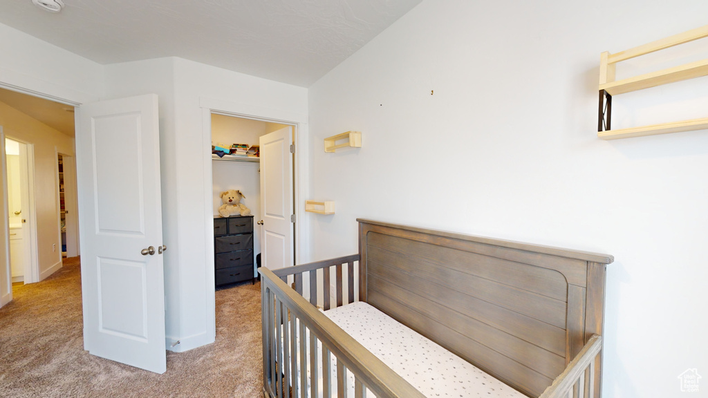 Carpeted bedroom with a crib