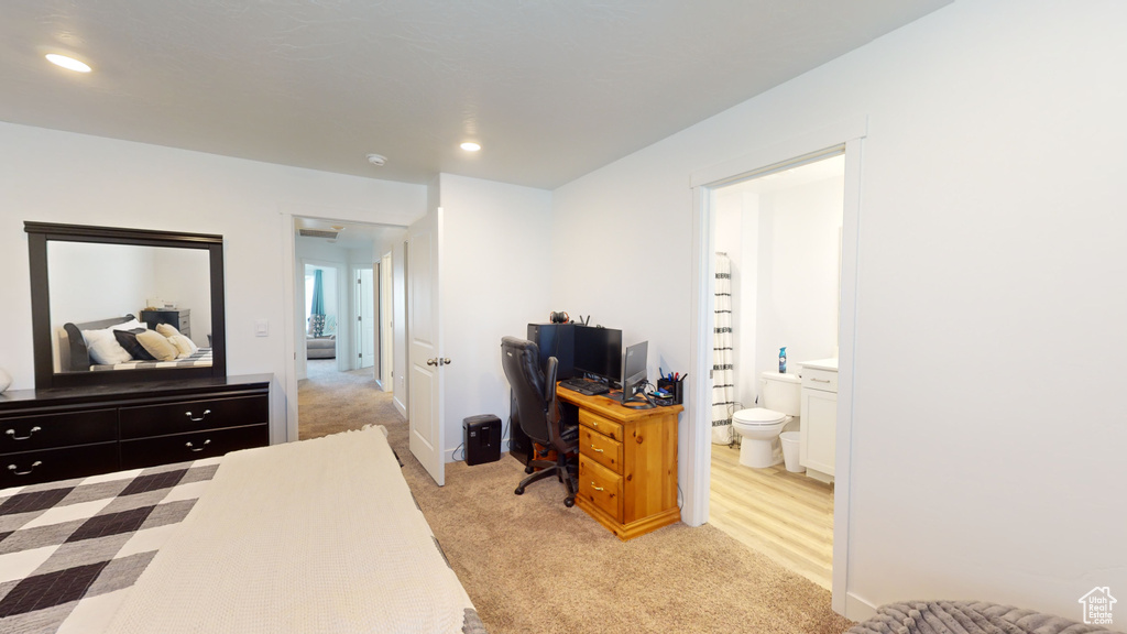 Carpeted bedroom featuring ensuite bathroom