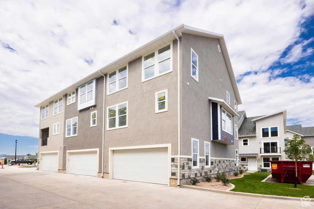 View of side of property featuring a garage