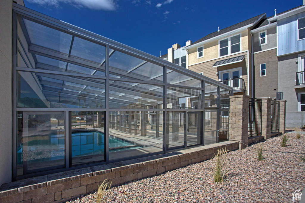 Rear view of property with a community pool