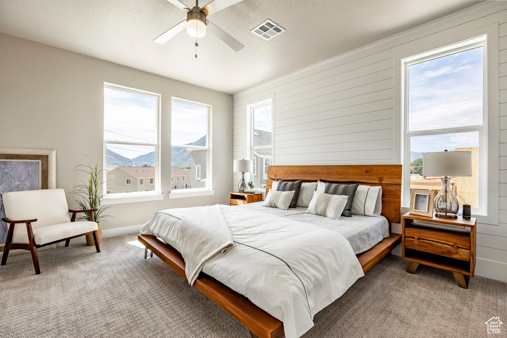 Carpeted bedroom featuring ceiling fan