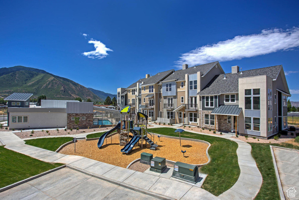 View of play area featuring a lawn and a mountain view