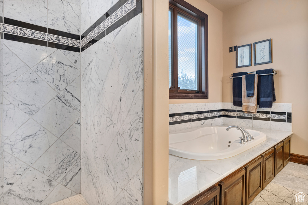 Bathroom featuring tile patterned flooring and a bathtub