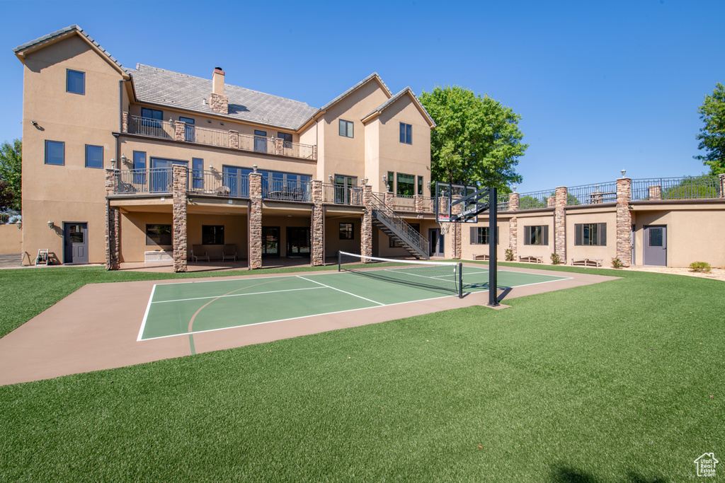 View of sport court featuring a yard