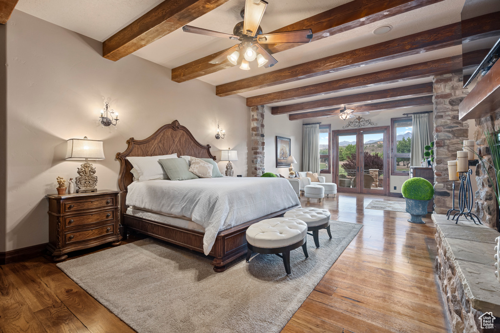 Bedroom featuring light hardwood / wood-style floors, ceiling fan, and beamed ceiling