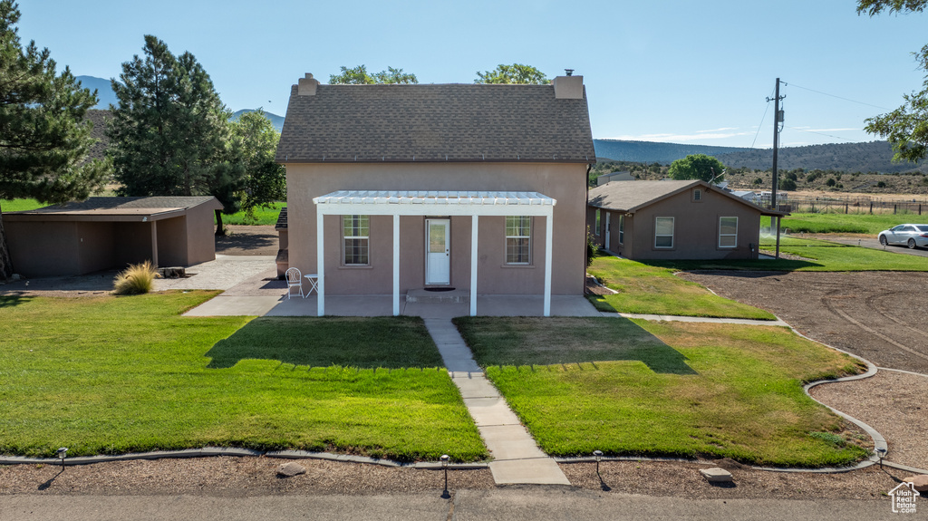 View of front of house with a patio area, a front lawn, and a pergola