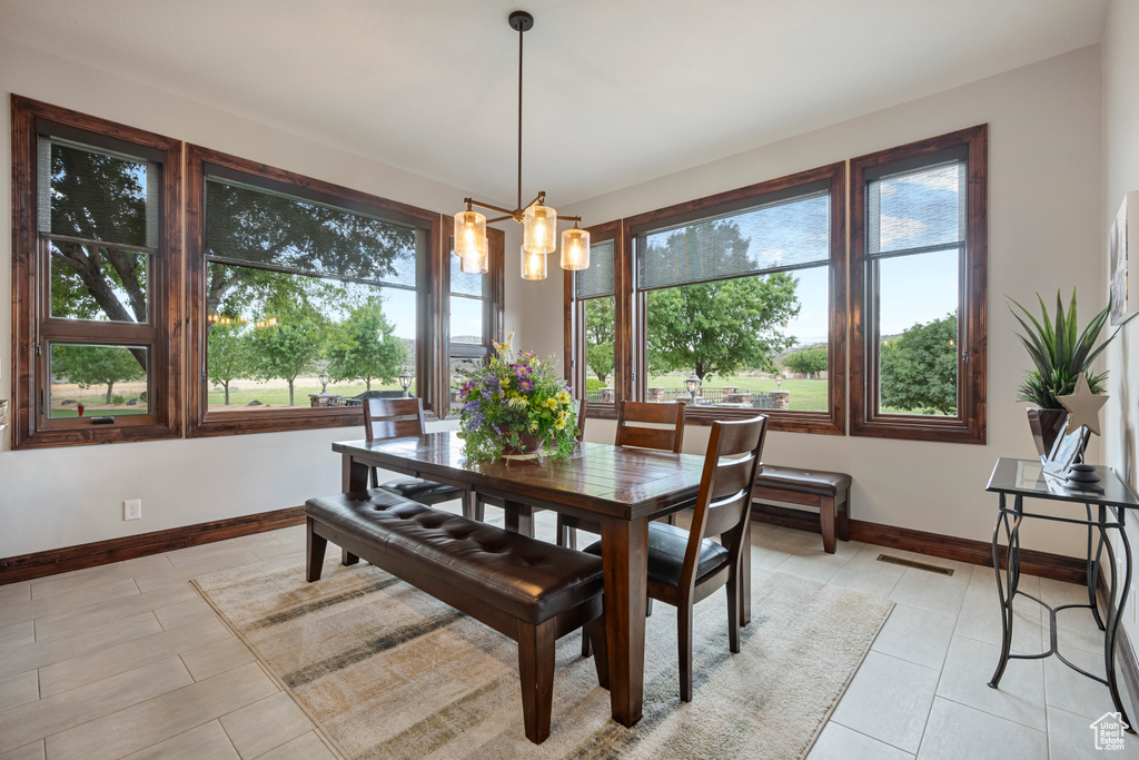 Dining space featuring an inviting chandelier and light tile patterned floors