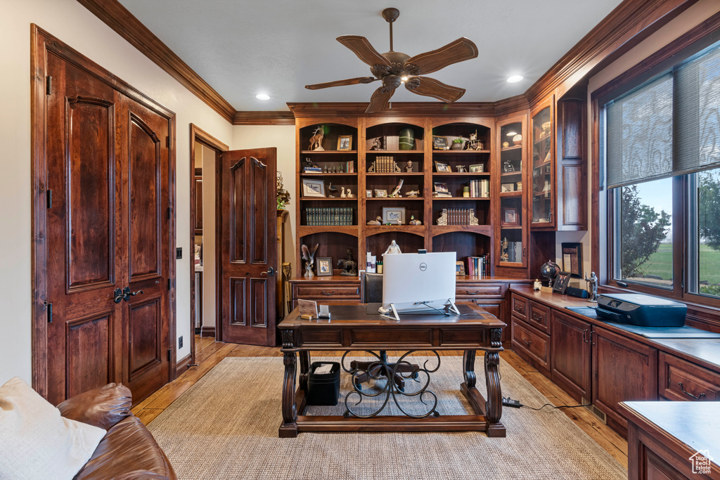 Office space with crown molding, light wood-type flooring, and ceiling fan