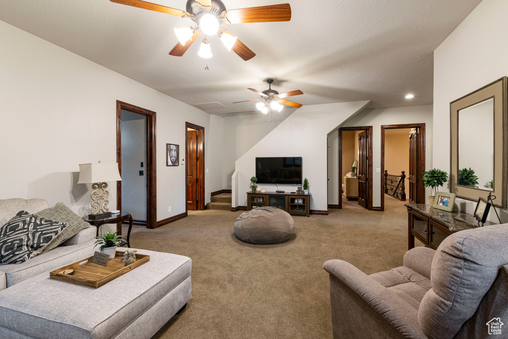 Living room with light carpet and ceiling fan