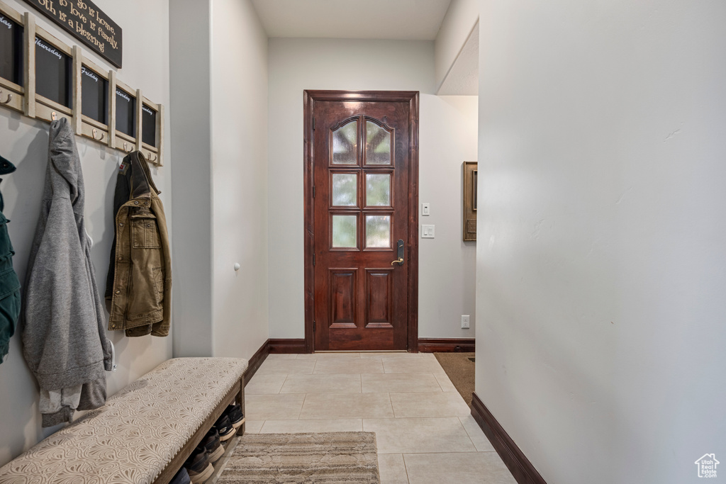 Mudroom with light tile patterned flooring