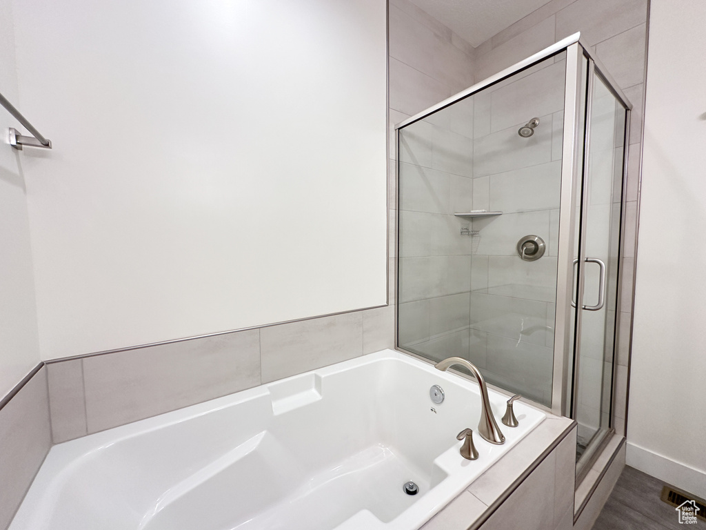 Bathroom featuring separate shower and tub