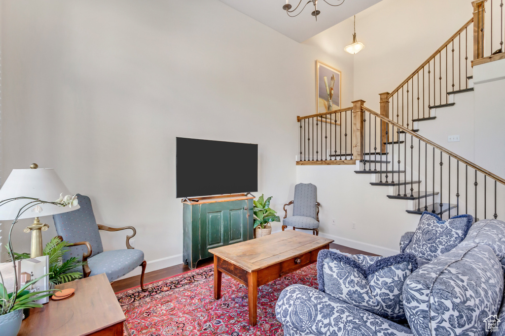 Living room with wood-type flooring and a high ceiling