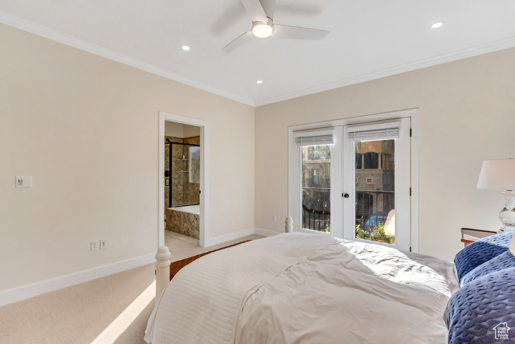 Carpeted bedroom featuring ensuite bathroom, access to outside, ceiling fan, and ornamental molding