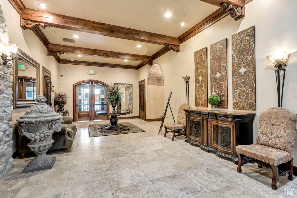 Tiled living room with french doors and ornamental molding