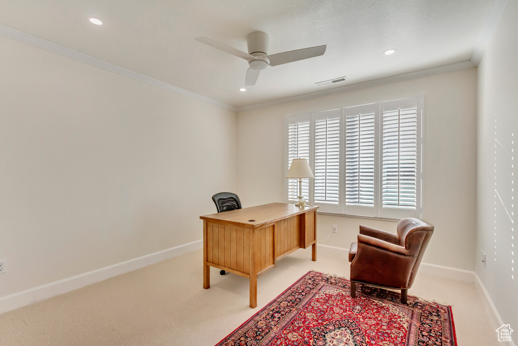 Office space with crown molding, light carpet, and ceiling fan