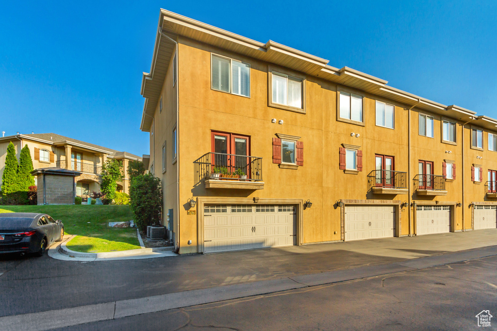 Exterior space featuring a balcony and a garage