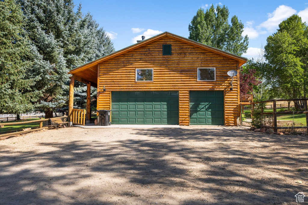 View of side of property with a garage