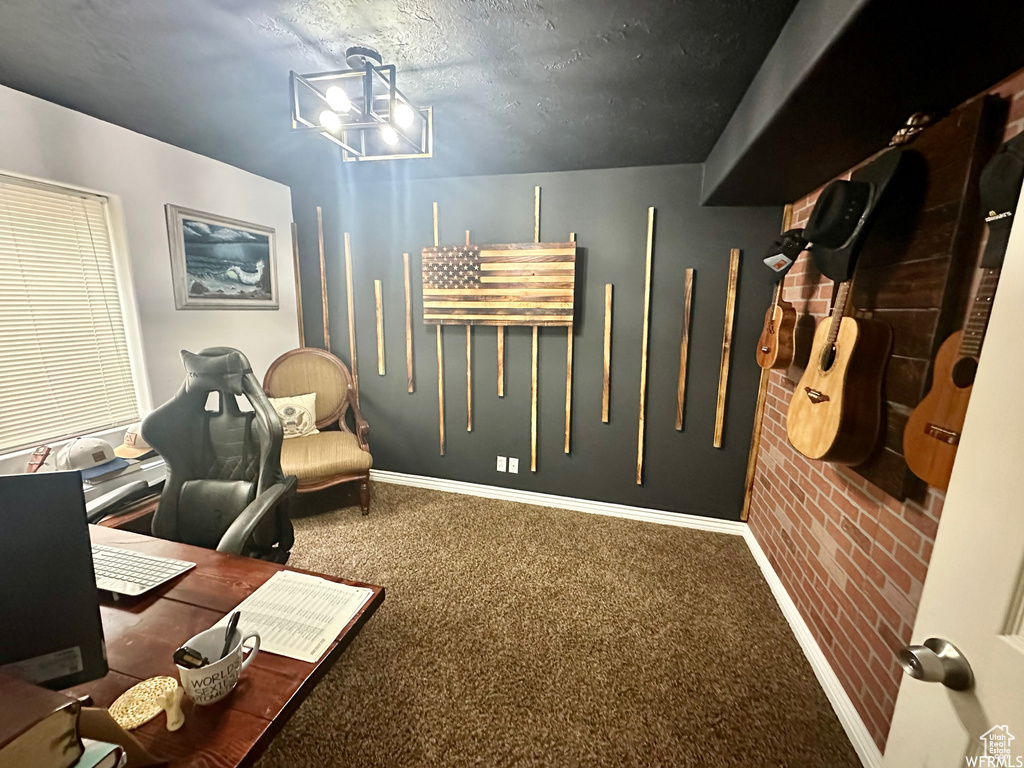 Carpeted office featuring a textured ceiling