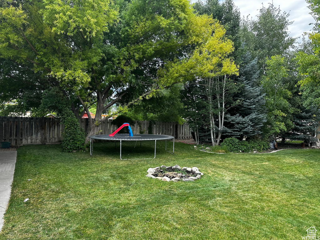 View of yard featuring a trampoline