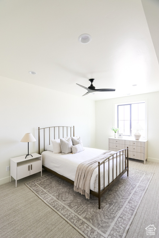 Carpeted bedroom featuring ceiling fan