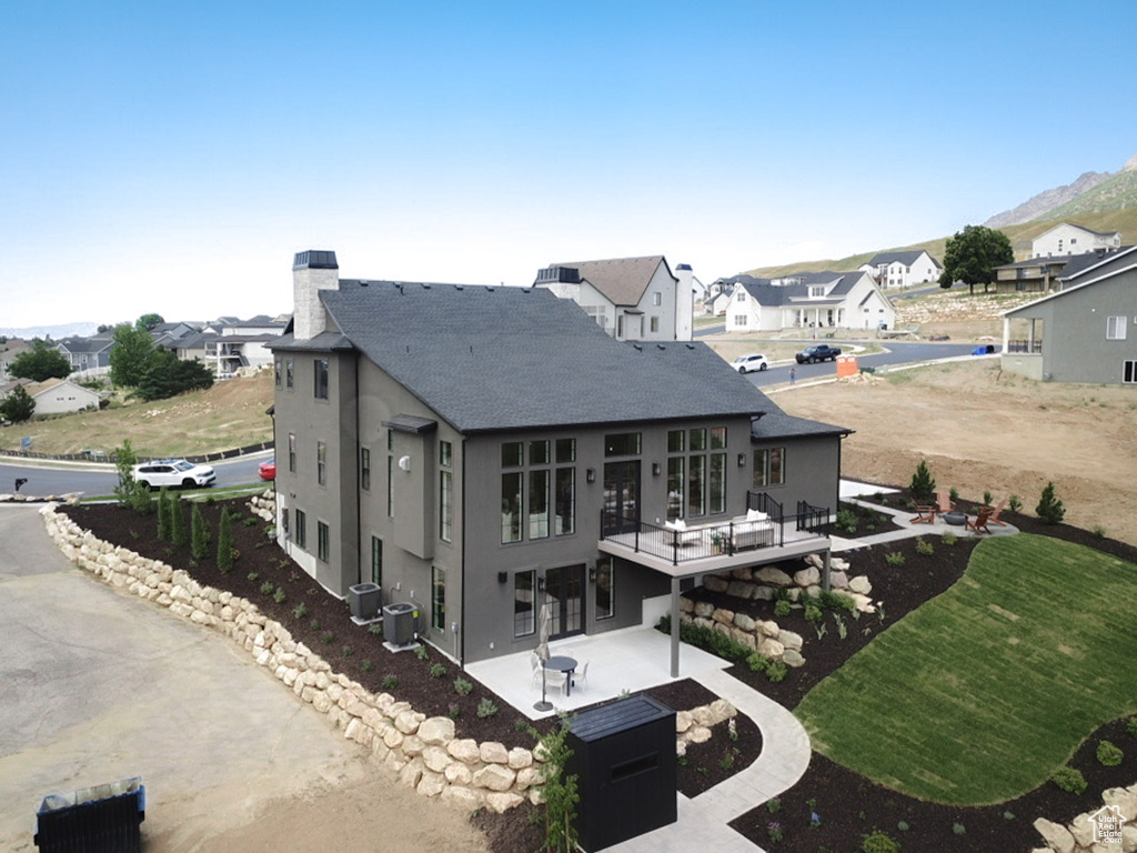 Rear view of house featuring a patio and central AC unit