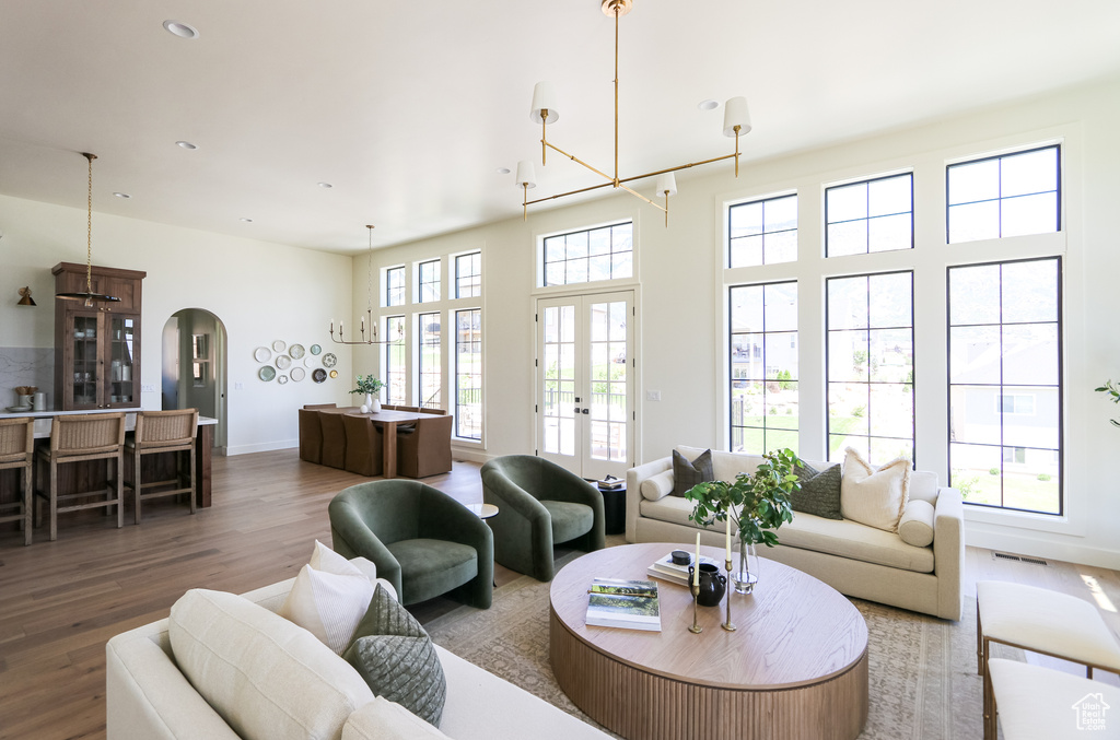 Living room featuring plenty of natural light, french doors, and hardwood / wood-style flooring