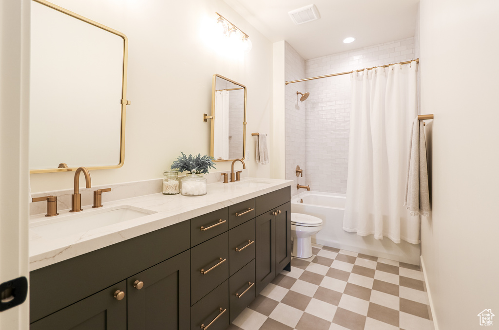 Full bathroom with shower / tub combo with curtain, toilet, tile patterned flooring, and double sink vanity