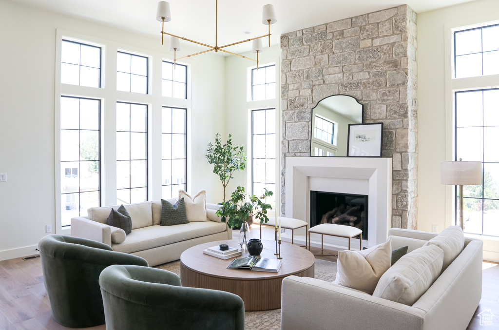 Living room featuring plenty of natural light, a fireplace, and wood-type flooring