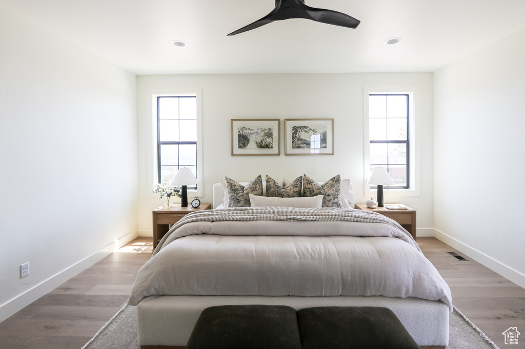 Bedroom with light hardwood / wood-style flooring and ceiling fan