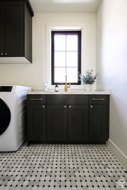 Laundry room featuring sink, cabinets, washer / dryer, and light tile patterned flooring