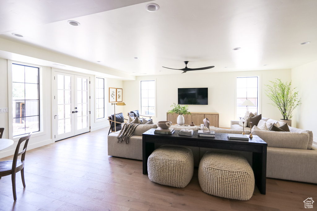 Living room with wood-type flooring, french doors, and ceiling fan