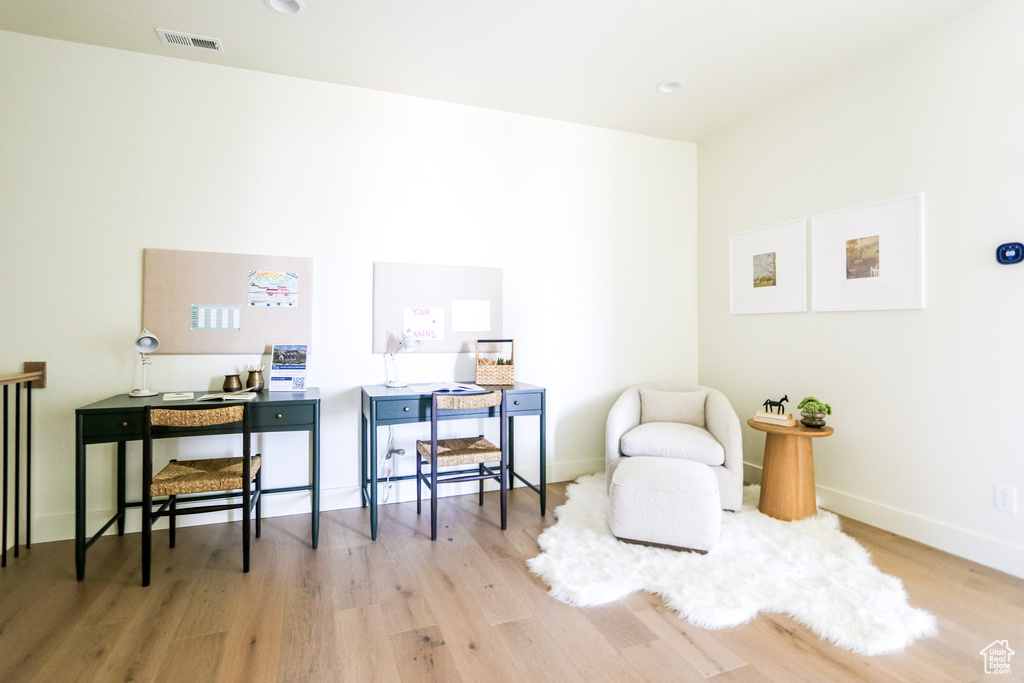 Office area with light hardwood / wood-style floors