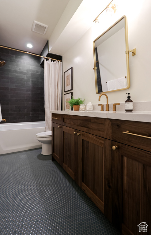 Full bathroom with vanity, toilet, and shower / tub combo