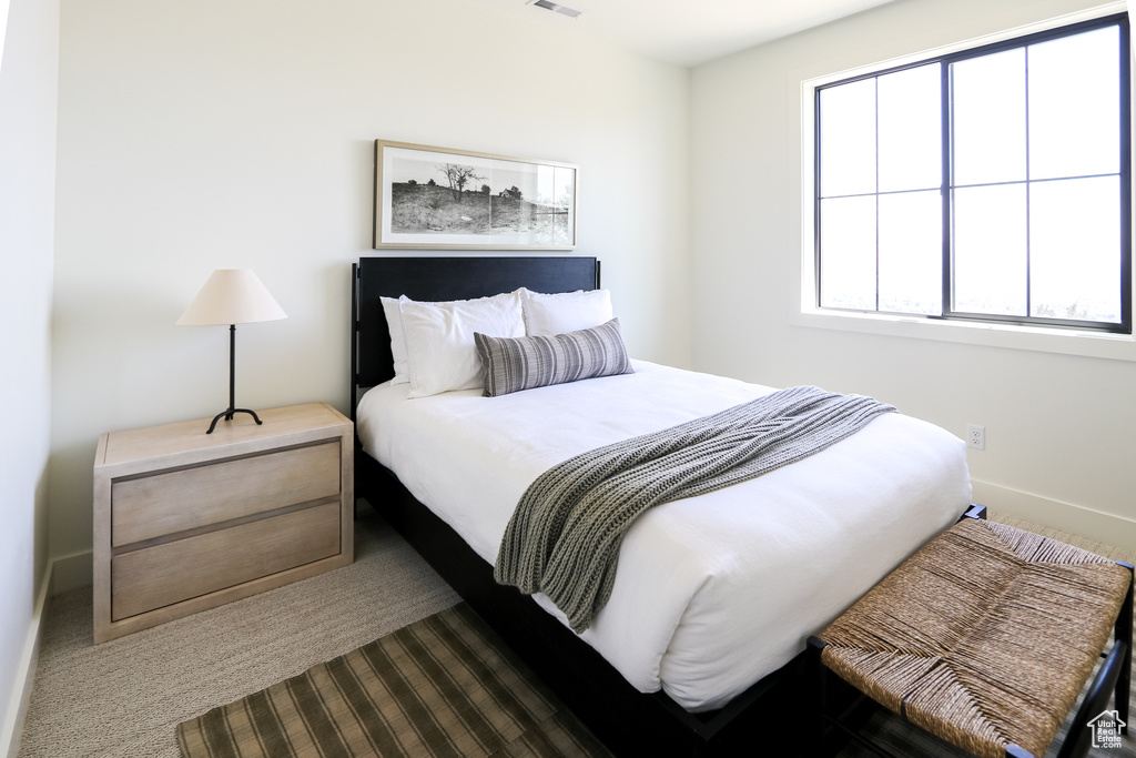 Carpeted bedroom with multiple windows