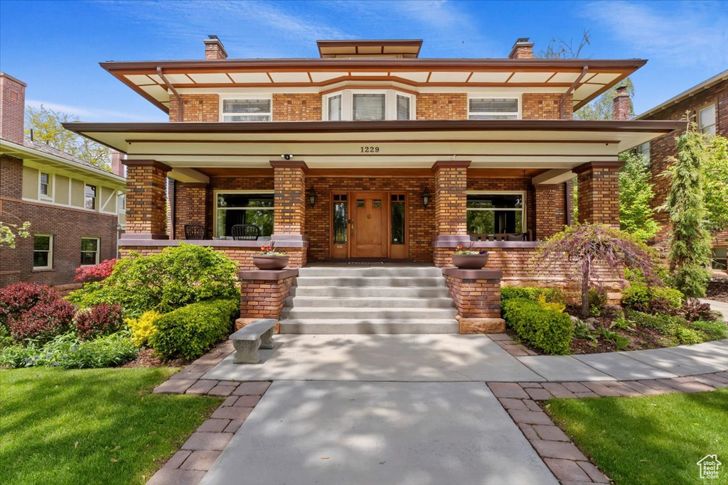 View of front of property with a front lawn and a porch