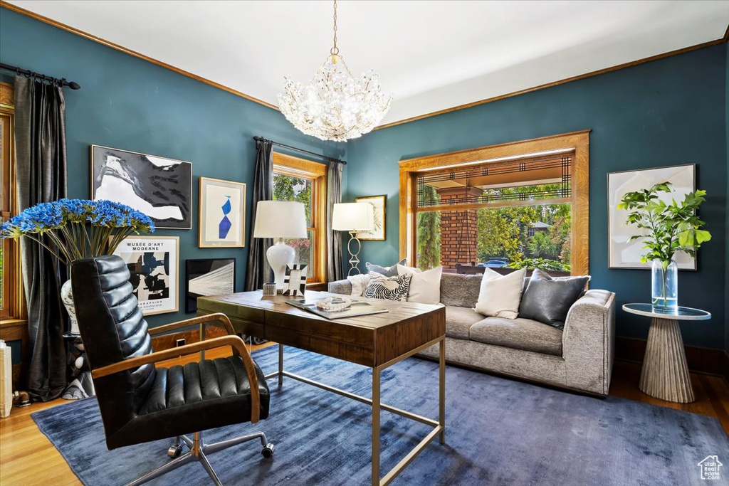 Office area featuring a notable chandelier and hardwood / wood-style floors