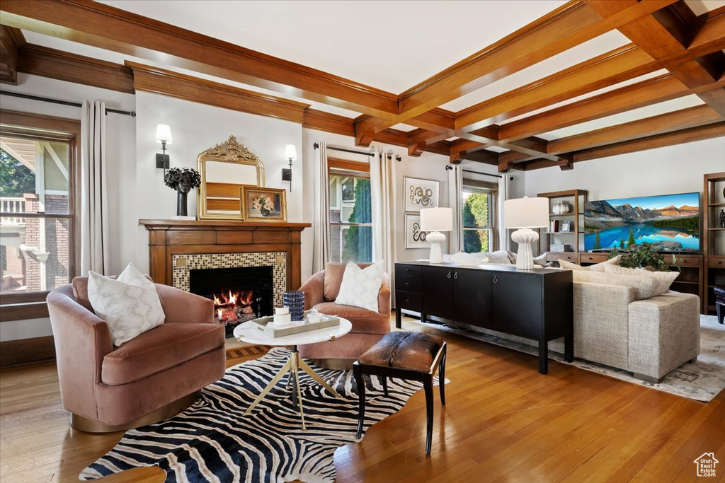 Living room featuring coffered ceiling, wood-type flooring, beam ceiling, and a fireplace