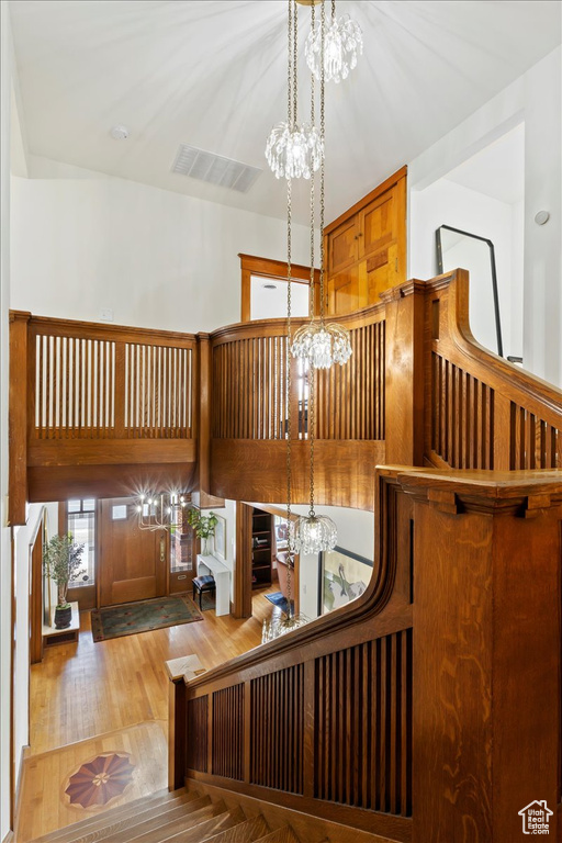 Interior space with hardwood / wood-style flooring and a chandelier