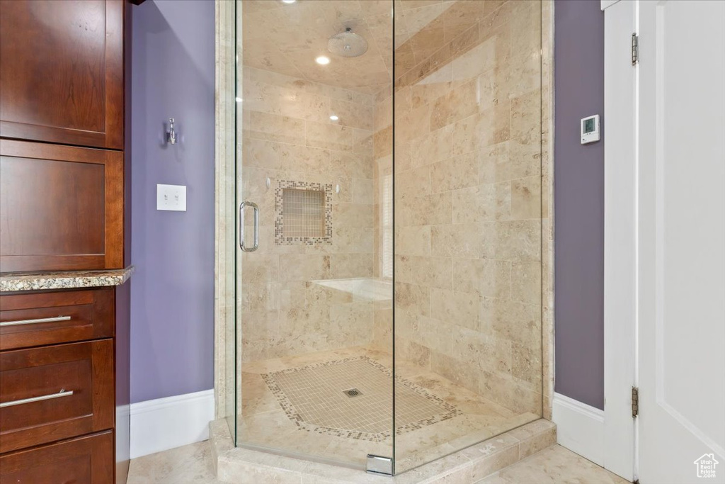 Bathroom with walk in shower and tile patterned flooring