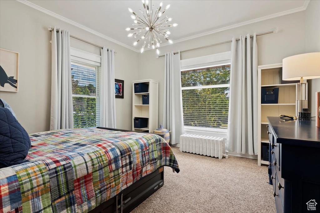 Bedroom featuring ornamental molding, carpet, radiator, and multiple windows